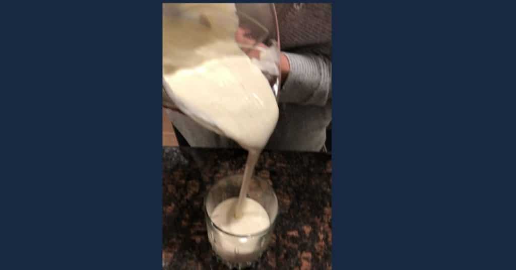 pouring creamy sugar free almond milk eggnog keto 